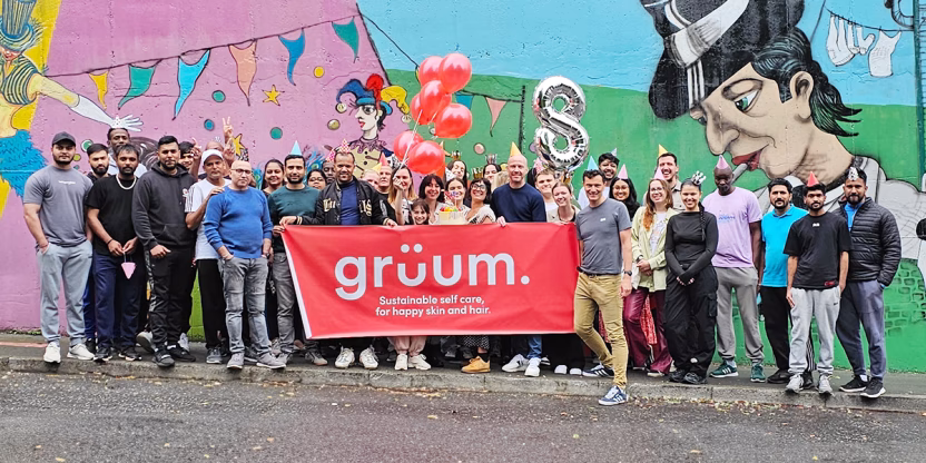 Group holding Gruum banner outside