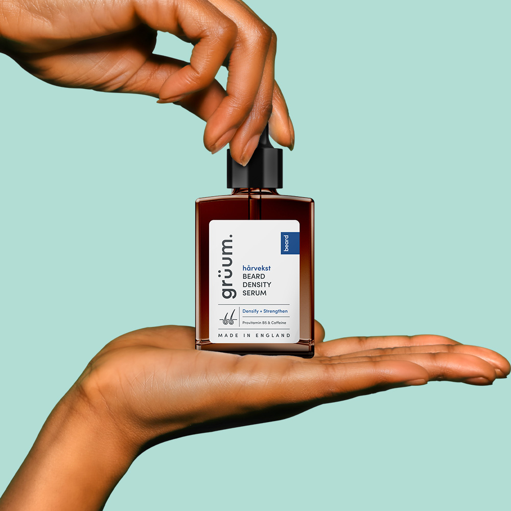 Hand holding beard density serum