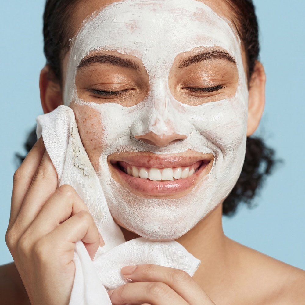 Woman removing face mask with cloth.