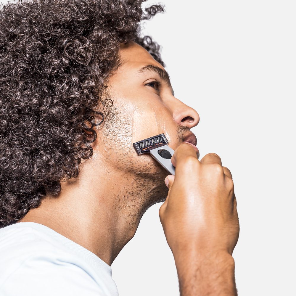 Person shaving with razor
