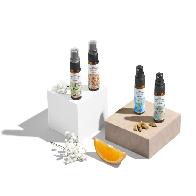 Four fragrance bottles with floral designs.