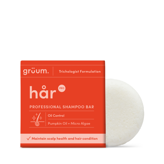 Orange shampoo bar packaging with white soap.