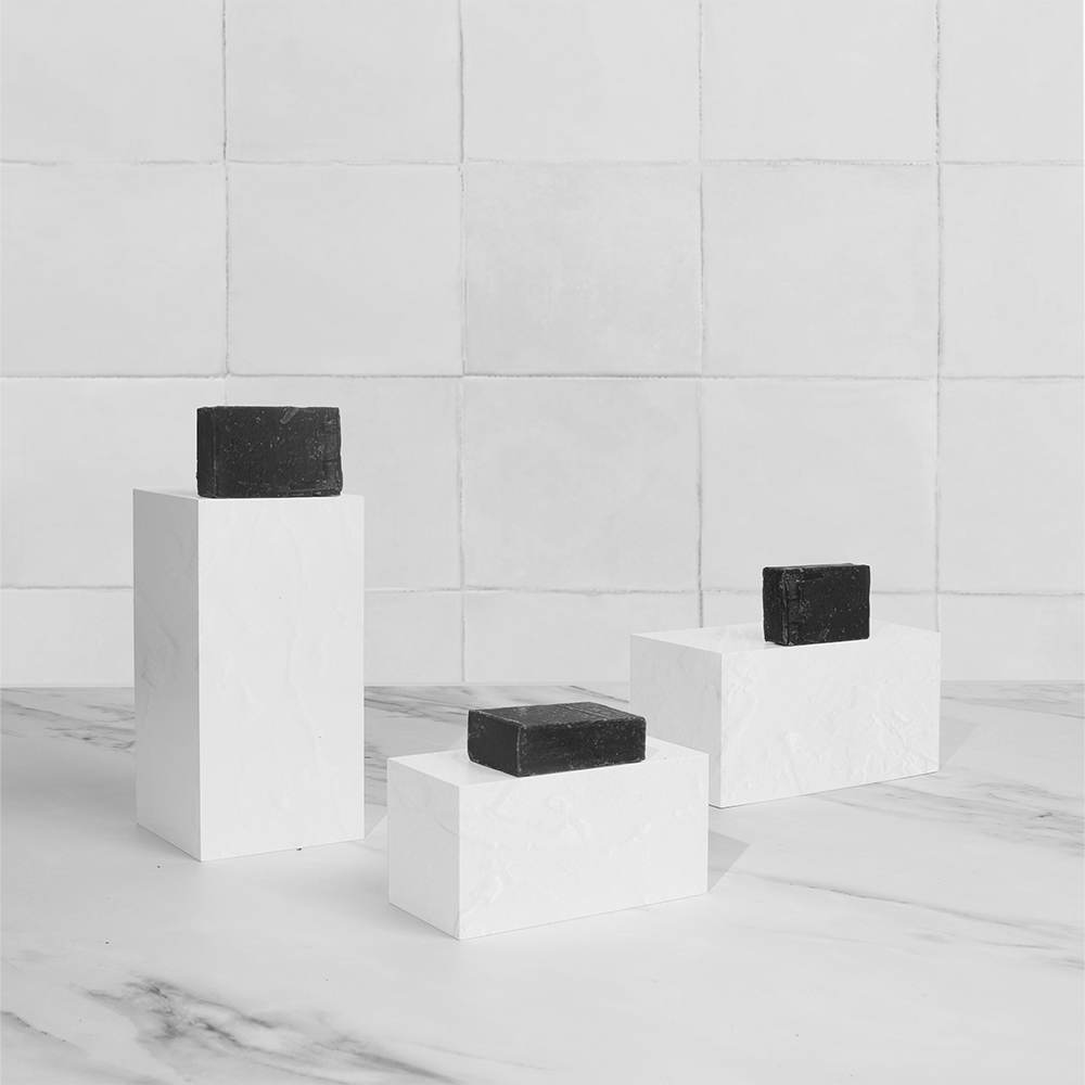 Three black soaps on pedestals