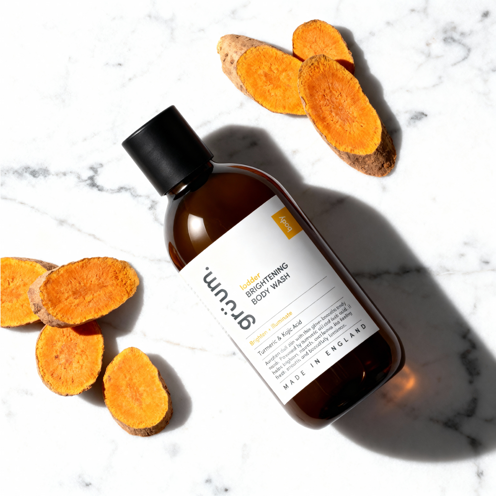 Bottle and orange slices on marble surface