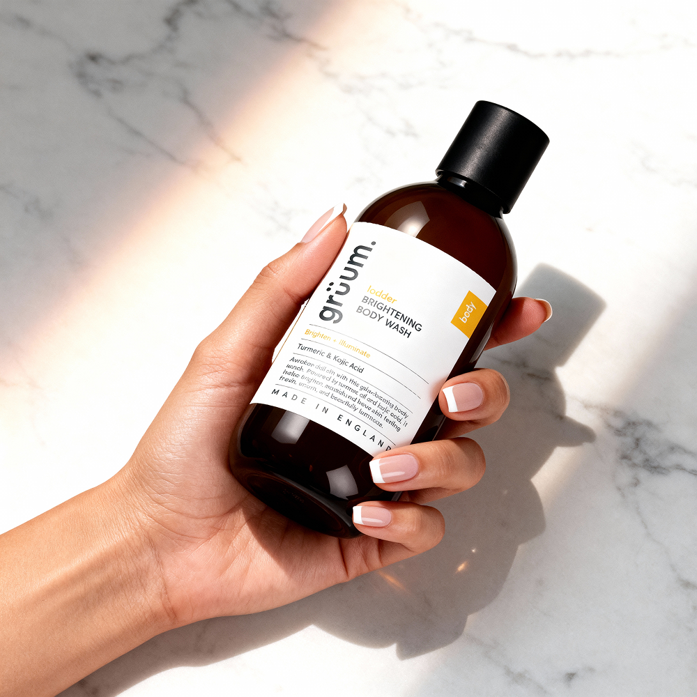 Hand holding body wash bottle