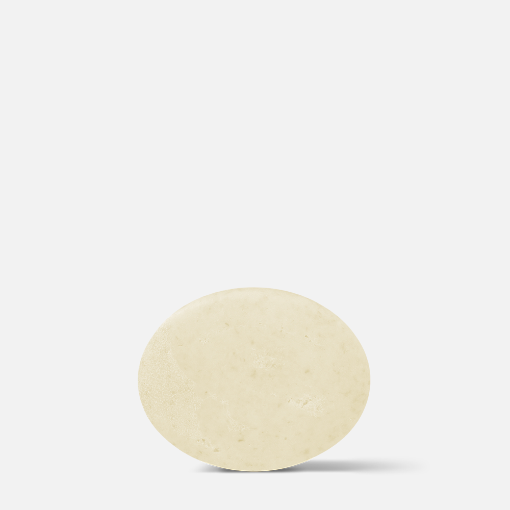 Round soap bar on white background.