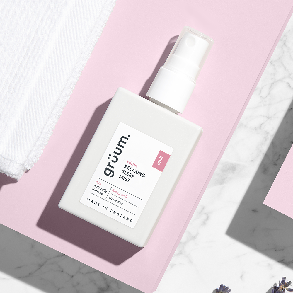 Sleep mist bottle on pink surface.