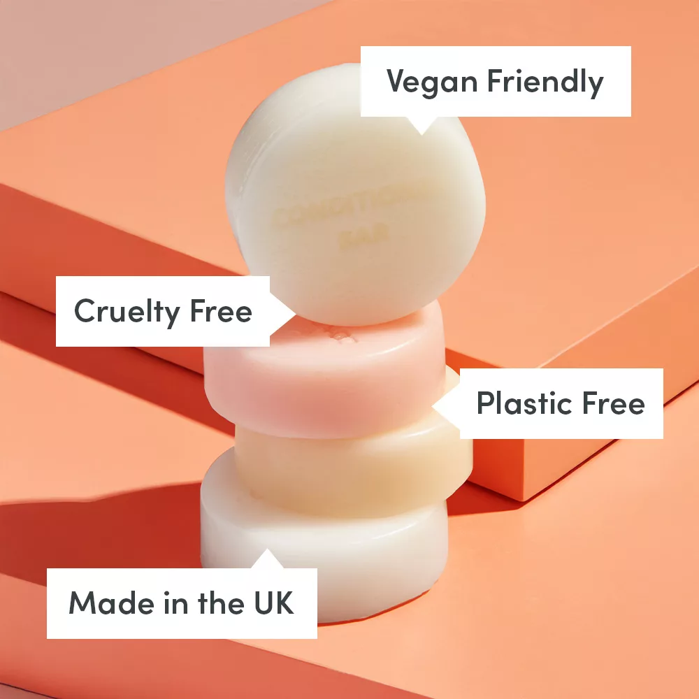 Stacked soap bars on orange background.