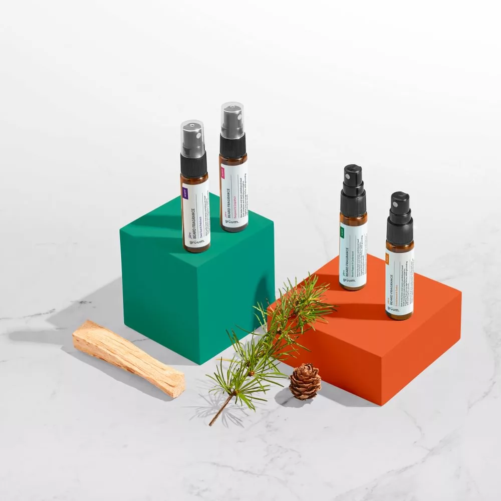 Four spray bottles on colored blocks.