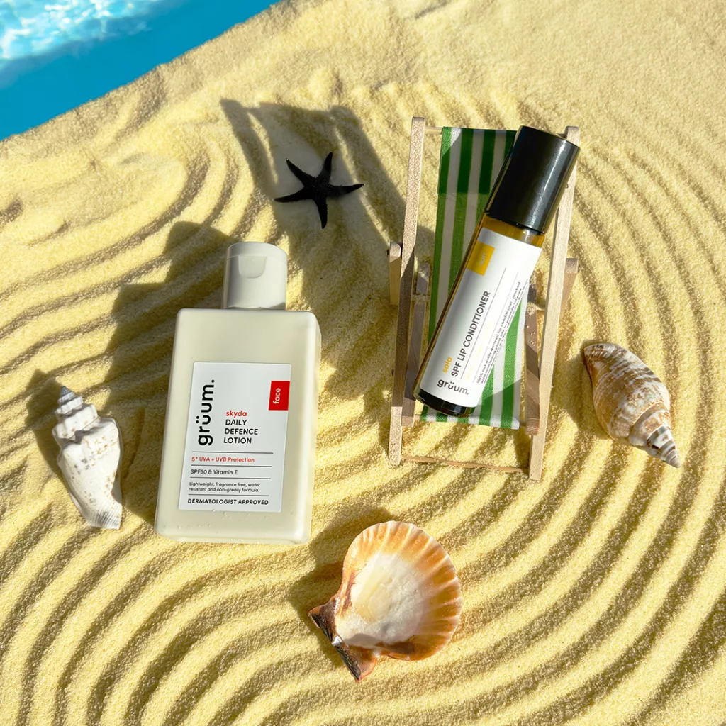 Sunscreen and bottle on sandy beach