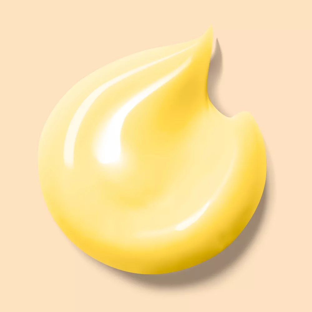 Yellow cream smear on beige background.