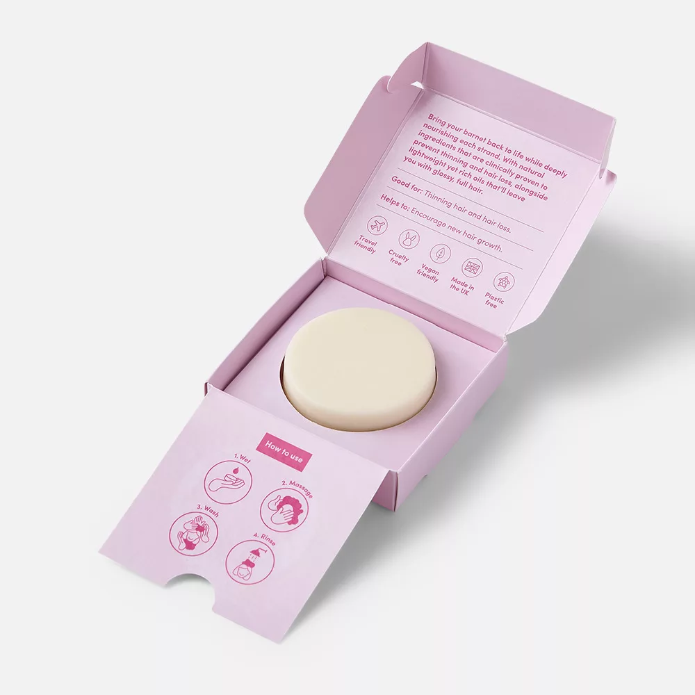 Pink box with round soap inside.