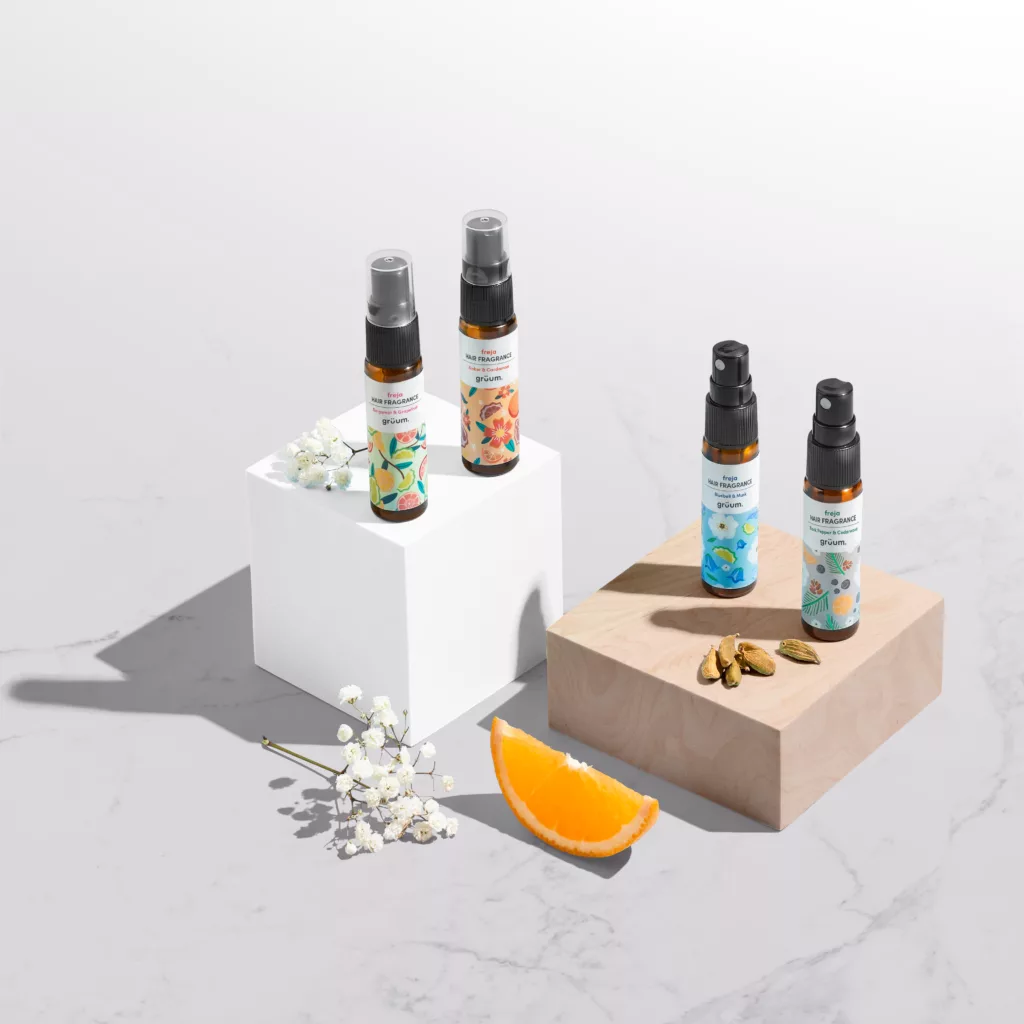 Four fragrance bottles with citrus and flowers