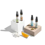 Four fragrance bottles with floral designs.