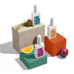 Three perfume bottles on colorful blocks.