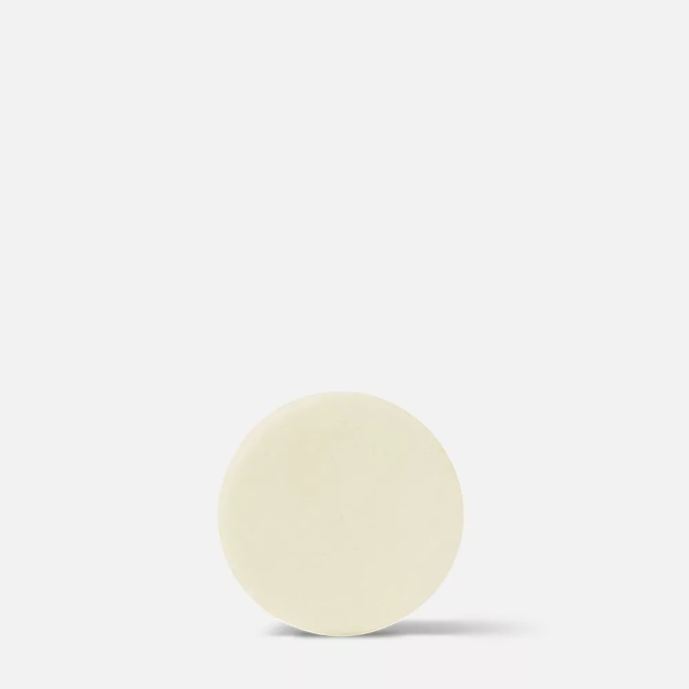Beige circular object on white background.