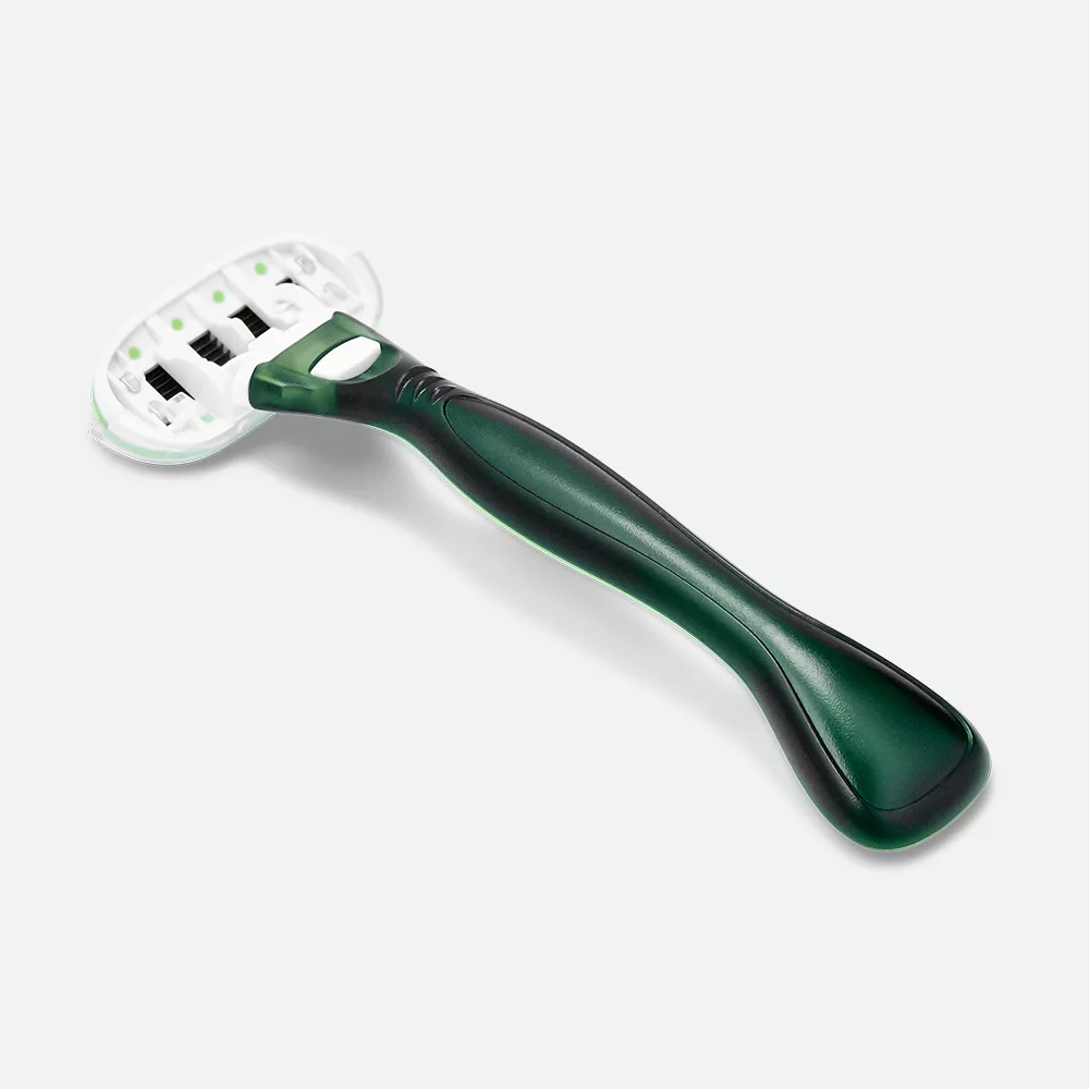 Green-handled razor on white background.