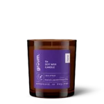 Purple soy wax candle in glass jar.