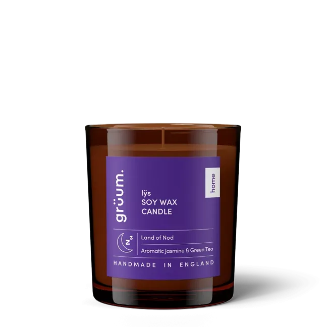 Purple soy wax candle in glass jar.