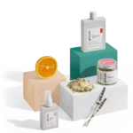 Assorted skincare products with orange slice.