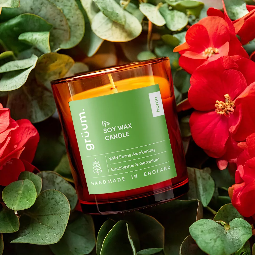 Soy wax candle among red flowers