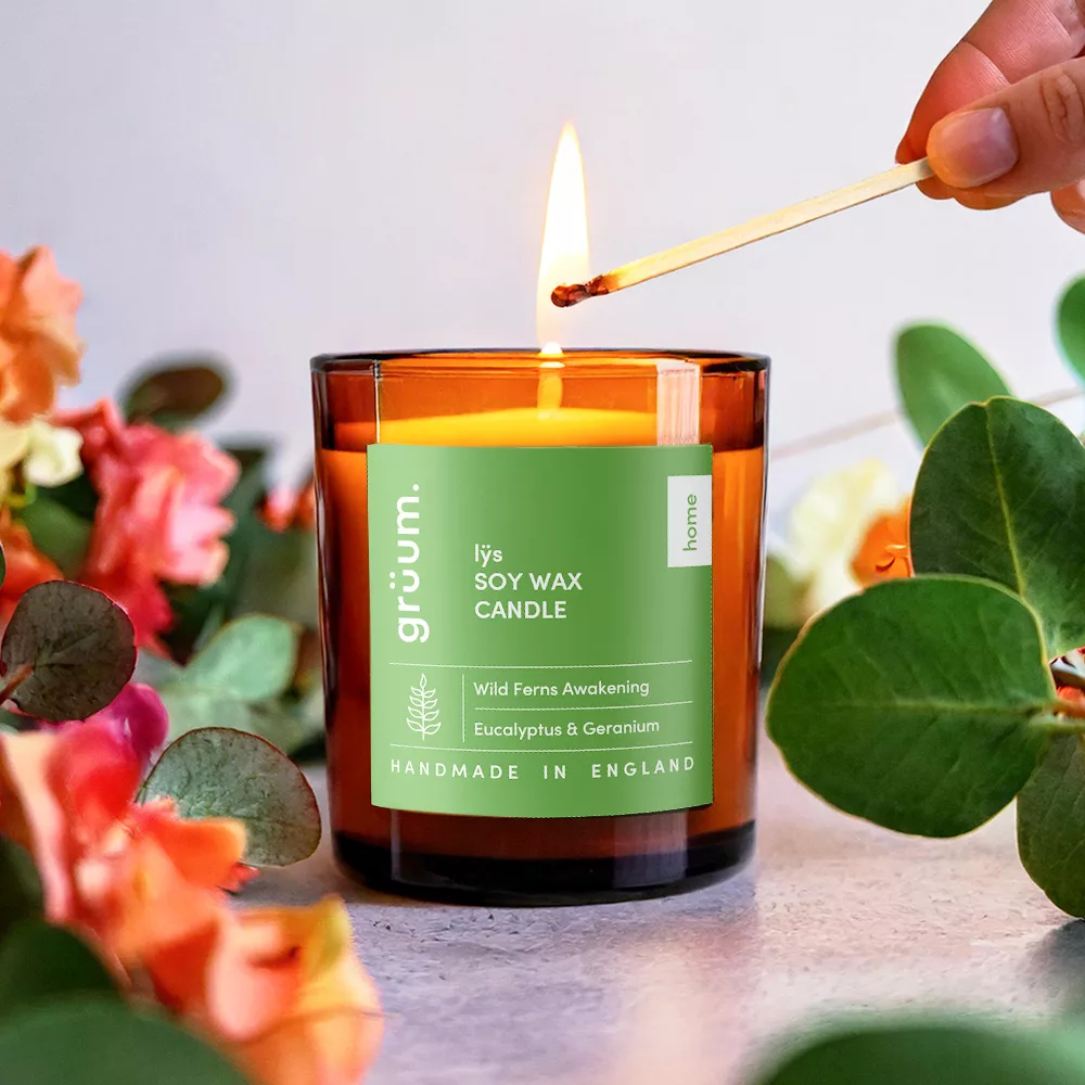 Lighting soy wax candle with matchstick.